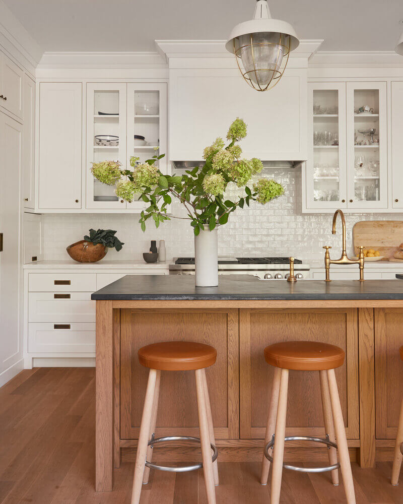 White textured subway tile backsplash complementing sleek shaker cabinets in a kitchen.