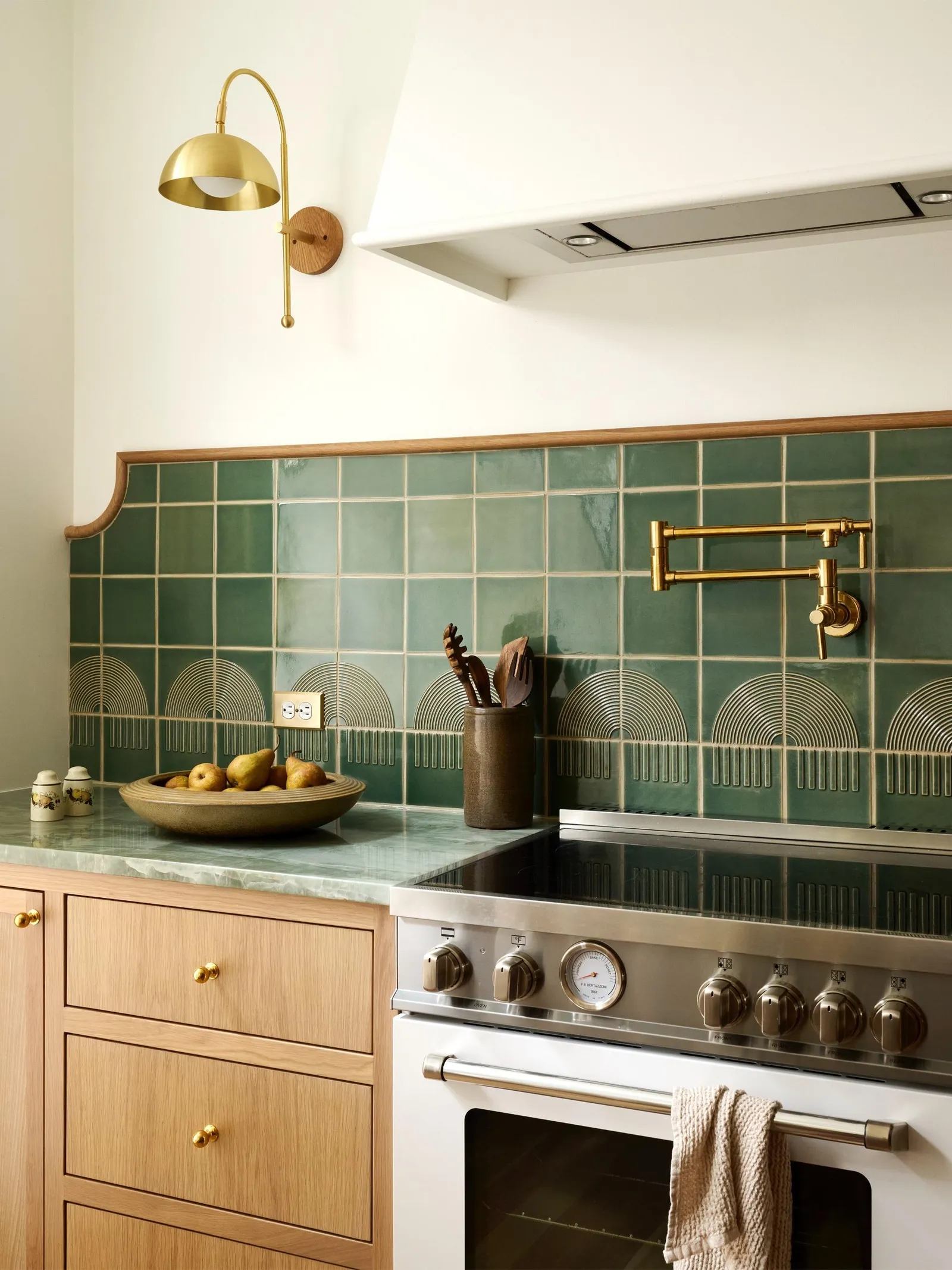 Custom-cut square tiles arranged to create an elegant arched kitchen backsplash.