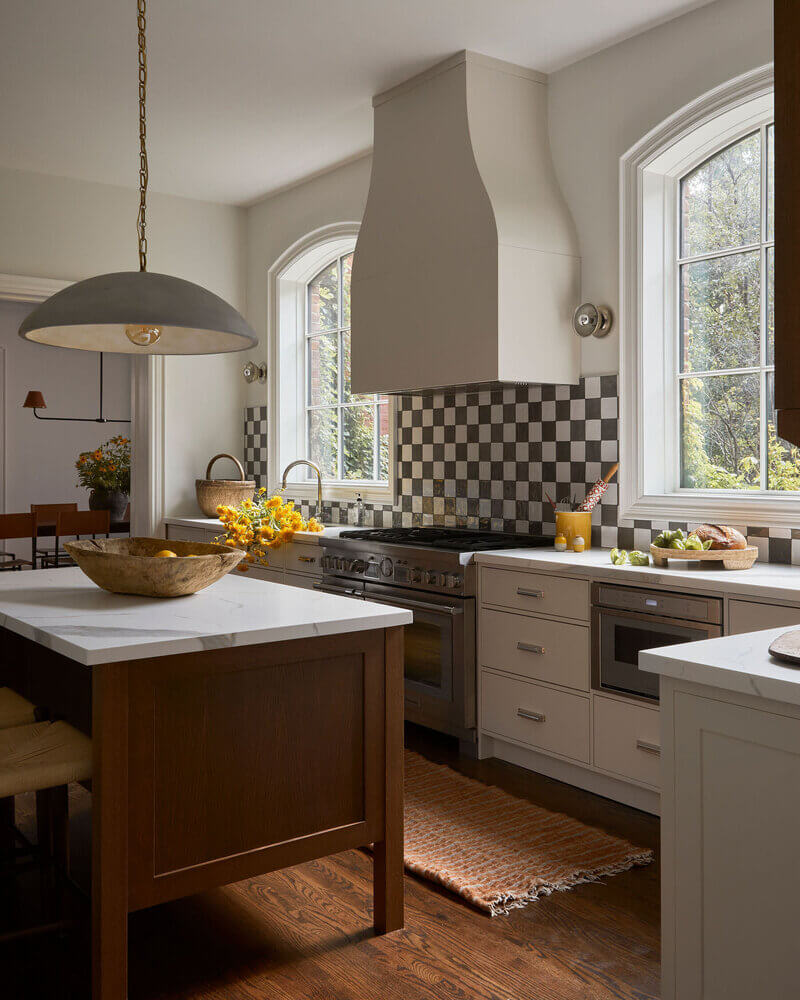 Neutral square tiles arranged in a classic checkerboard pattern for a kitchen backsplash.